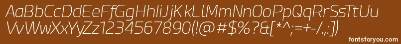 EsphimereExtraLightItalic-fontti – valkoiset fontit ruskealla taustalla