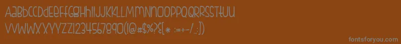 BmdFishfingers-fontti – harmaat kirjasimet ruskealla taustalla