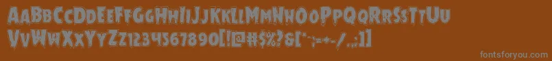 Mrsmonsteracad-fontti – harmaat kirjasimet ruskealla taustalla