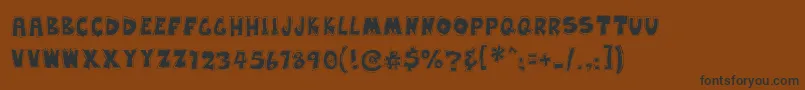 EarwaxWit Font – Black Fonts on Brown Background