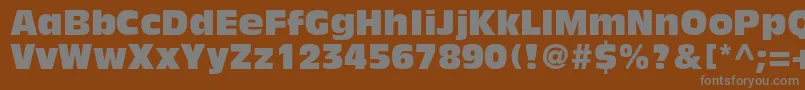 AntiqueolivestdCompact-fontti – harmaat kirjasimet ruskealla taustalla