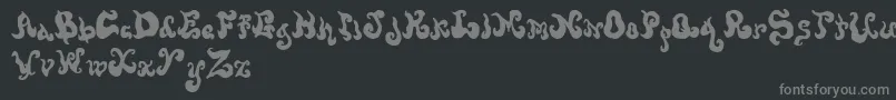 Screwymeltedwax-fontti – harmaat kirjasimet mustalla taustalla