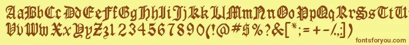 フォントAnglossk – 茶色の文字が黄色の背景にあります。