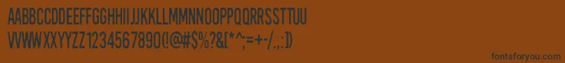 フォントKirkuvanpunainenKirsikka – 黒い文字が茶色の背景にあります