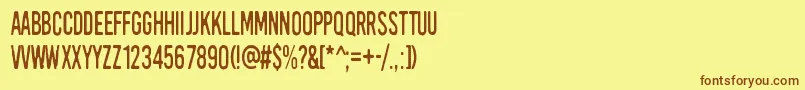 フォントKirkuvanpunainenKirsikka – 茶色の文字が黄色の背景にあります。
