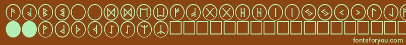 フォントPrRunestones2 – 緑色の文字が茶色の背景にあります。