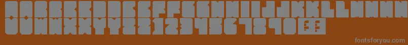 PartyHard-fontti – harmaat kirjasimet ruskealla taustalla