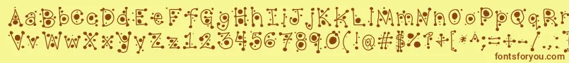 フォントCropCircles – 茶色の文字が黄色の背景にあります。