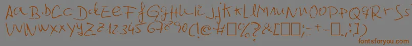 フォントJcgr61 – 茶色の文字が灰色の背景にあります。