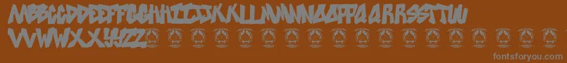 Sweetasrevenge-Schriftart – Graue Schriften auf braunem Hintergrund