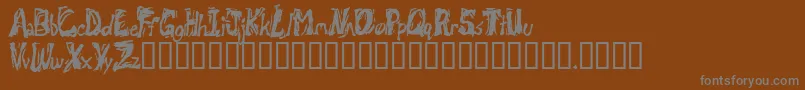 Retsuc-fontti – harmaat kirjasimet ruskealla taustalla