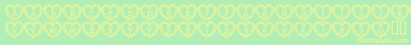 フォント101HeartDeco – 黄色の文字が緑の背景にあります