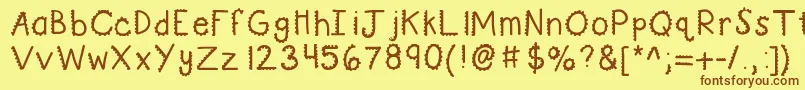 フォントKbturninggears – 茶色の文字が黄色の背景にあります。