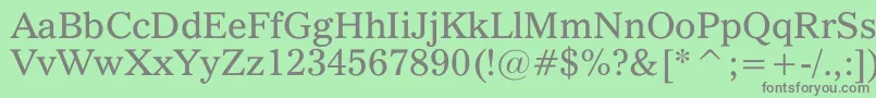 QuoVadis-fontti – harmaat kirjasimet vihreällä taustalla
