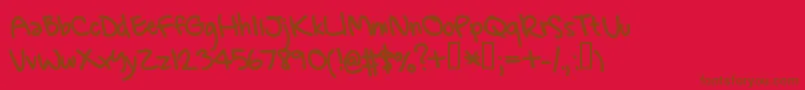 GregsHand-fontti – ruskeat fontit punaisella taustalla