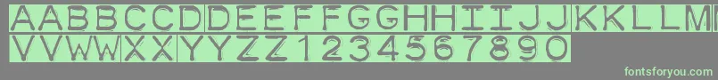 フォントDymofontinvers – 灰色の背景に緑のフォント