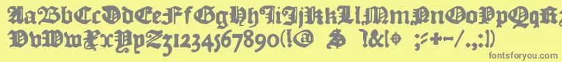 フォントDkCourant – 黄色の背景に灰色の文字