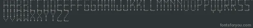 Fonte EspinudaTfb – fontes cinzas em um fundo preto