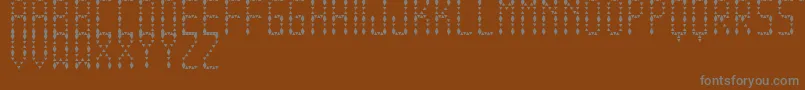 Czcionka EspinudaTfb – szare czcionki na brązowym tle
