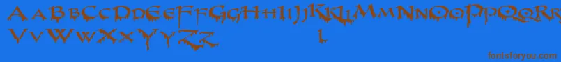 フォントPrUncialCreepyWide – 茶色の文字が青い背景にあります。