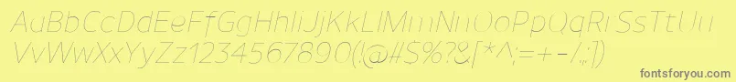 フォントUnimanUltralightitalic – 黄色の背景に灰色の文字