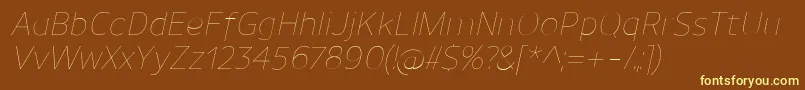 UnimanUltralightitalic-fontti – keltaiset fontit ruskealla taustalla