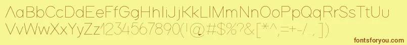 フォントAdam – 茶色の文字が黄色の背景にあります。