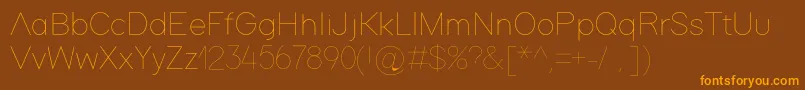 フォントAdam – オレンジ色の文字が茶色の背景にあります。