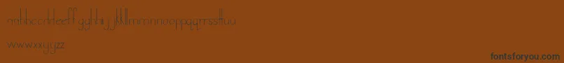 LandDownunder-Schriftart – Schwarze Schriften auf braunem Hintergrund
