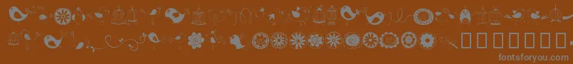 Czcionka DoodleDings1BirdsCages – szare czcionki na brązowym tle