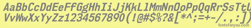 Nk57MonospaceScBdIt-fontti – harmaat kirjasimet keltaisella taustalla