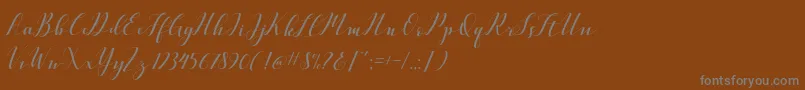 フォントVellesaScriptDemo – 茶色の背景に灰色の文字