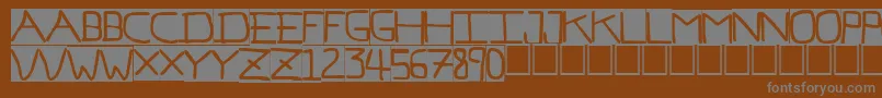 PfVeryverybadfont7Inverted-fontti – harmaat kirjasimet ruskealla taustalla