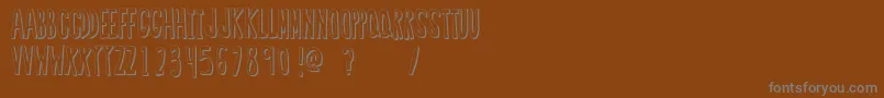 RegularFont2-fontti – harmaat kirjasimet ruskealla taustalla