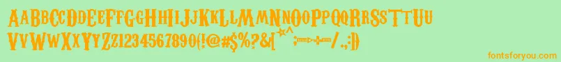 フォントCarnivaleeFreakshow – オレンジの文字が緑の背景にあります。