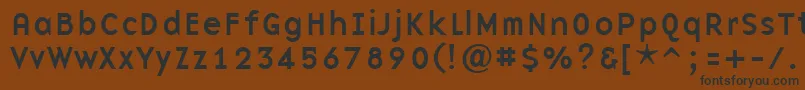 フォントBasenineRegular – 黒い文字が茶色の背景にあります