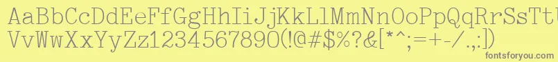 Typewriter-fontti – harmaat kirjasimet keltaisella taustalla