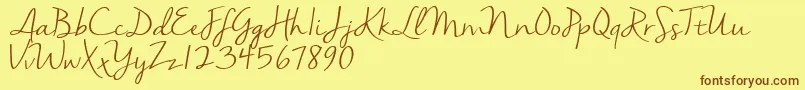 Nellasuedemo-Schriftart – Braune Schriften auf gelbem Hintergrund