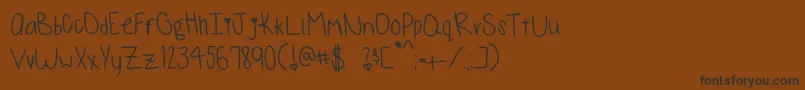 Czcionka MonkeysAndBananas – czarne czcionki na brązowym tle