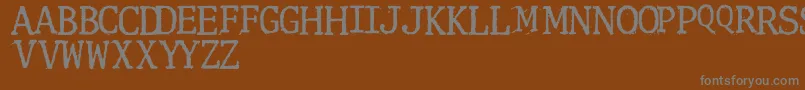 Clunk-Schriftart – Graue Schriften auf braunem Hintergrund