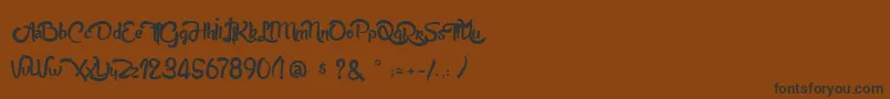 フォントAnabelleScriptLight – 黒い文字が茶色の背景にあります