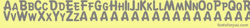 SuskeWiske-fontti – harmaat kirjasimet keltaisella taustalla