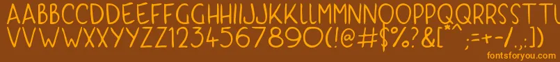 フォントKyriKaps – オレンジ色の文字が茶色の背景にあります。