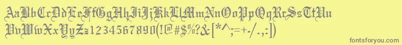 Oldeenglish-fontti – harmaat kirjasimet keltaisella taustalla