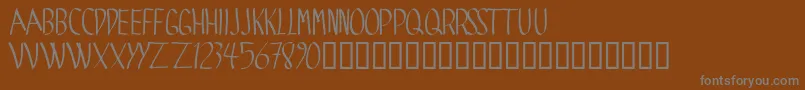 Spide-fontti – harmaat kirjasimet ruskealla taustalla