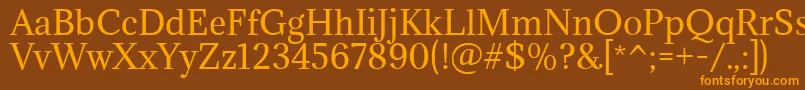 フォントAdaminaRegular – オレンジ色の文字が茶色の背景にあります。