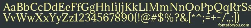 フォントAdaminaRegular – 黒い背景に黄色の文字