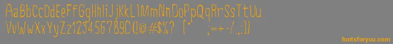 フォントCreepyCircus – オレンジの文字は灰色の背景にあります。