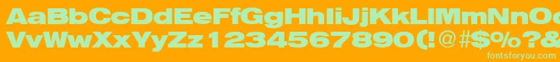 HelbaheavydbBold-Schriftart – Grüne Schriften auf orangefarbenem Hintergrund