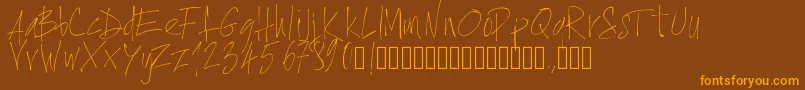 フォントPwxtrathin – オレンジ色の文字が茶色の背景にあります。